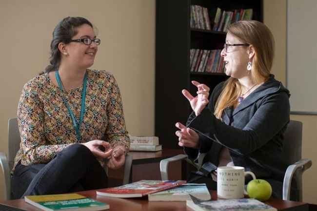 2 staff members talk