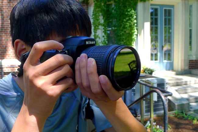 Student with camera to eye