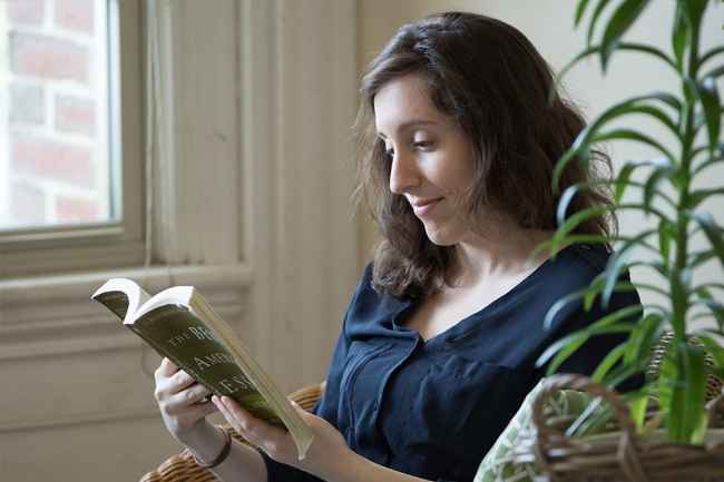 Young woman sits and reads