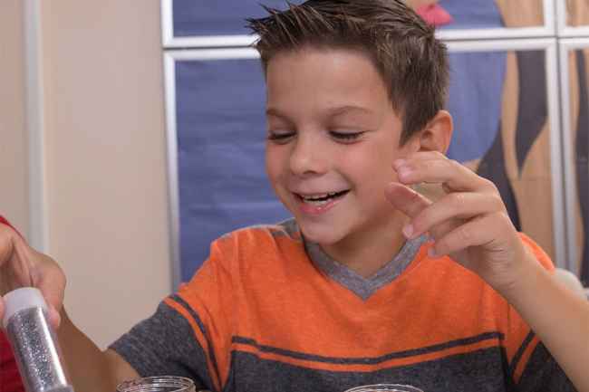 Child with shaker of glitter