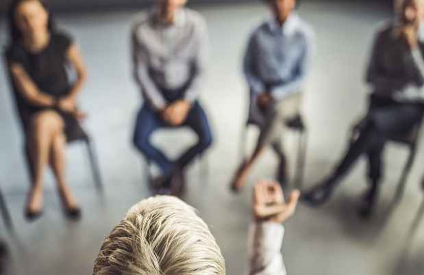 Woman speaking to a group of seated people