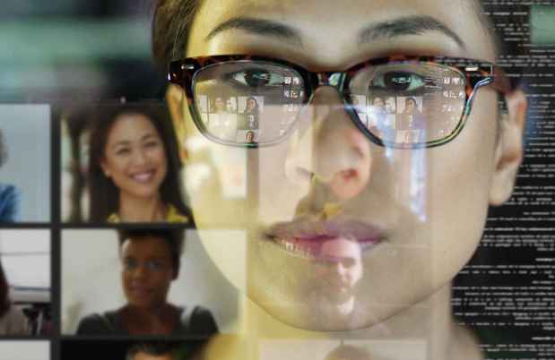Woman looks at screens