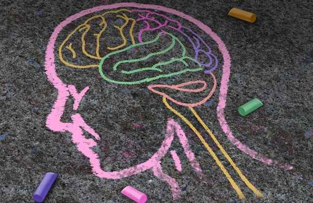 Crayon drawing of a head and brain on the ground
