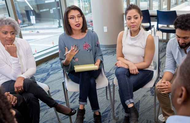 Clinician and patients in group therapy