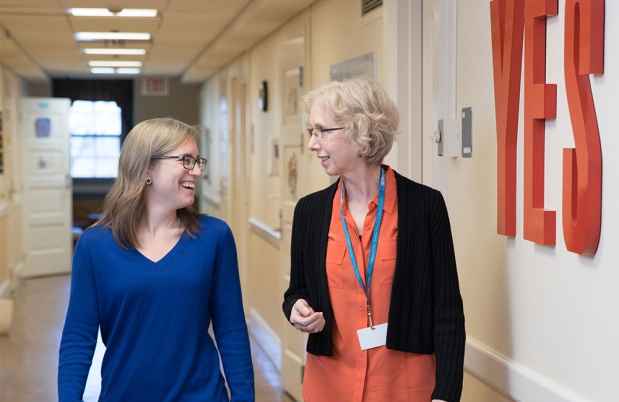 Two women walking in hallway
