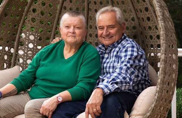 Two people sit in outdoor seating
