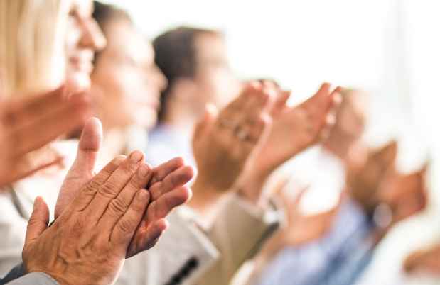 Row of people clapping