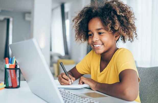 Girl smiling with on computer