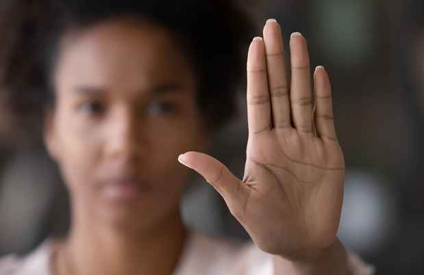 black woman with hand up