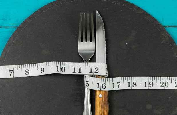 graphic image of a plate with fork and knife and measuring tape