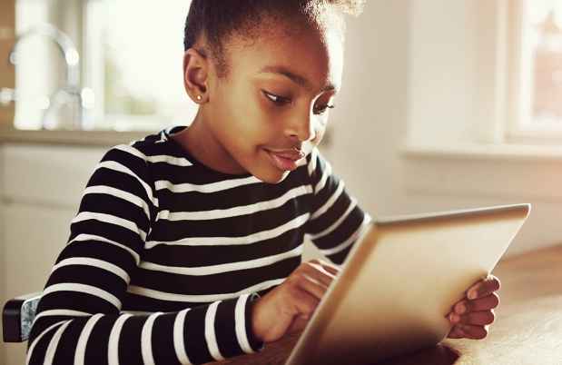 young girl working on tablet