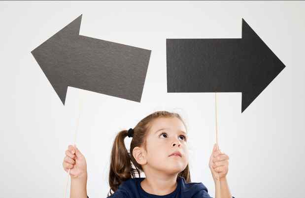 Child holding arrows pointing in different directions