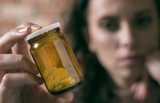Woman holding a pill bottle