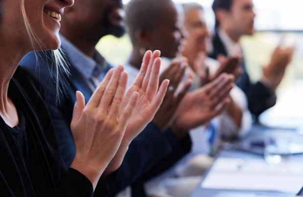 People in a row clapping