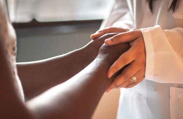 doctor holding patients hands