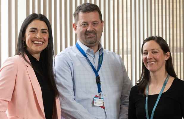 3 people pose for the camera