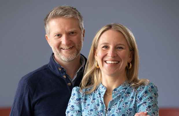 Couple posed for camera, blue gray background