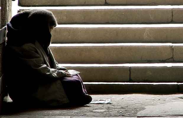 Person sitting outside by stairs