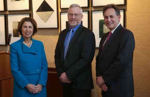 Three people posing for a picture