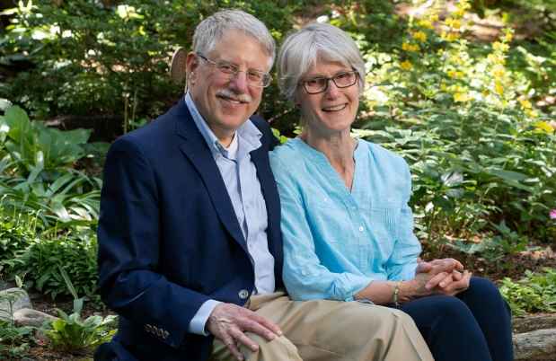 Two people sitting and smiling