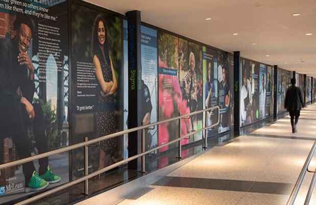 Long hallway with large posters on wall