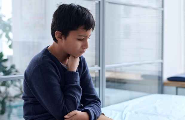 Boy sits in medical examination room
