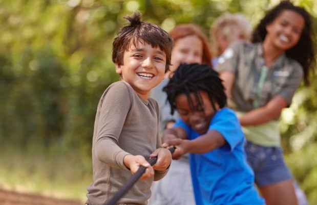 Children tugging on a rope and laughing
