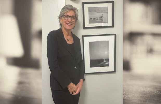 Woman smiling with framed art