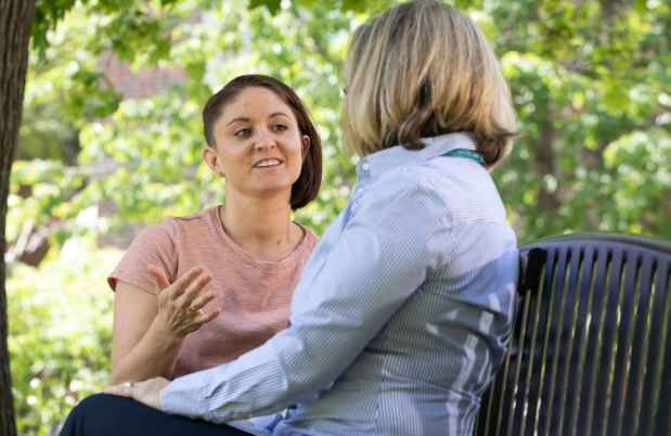 Patient speaking with a therapist on a park bench