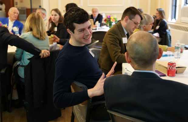 Group of people sitting at a table talking
