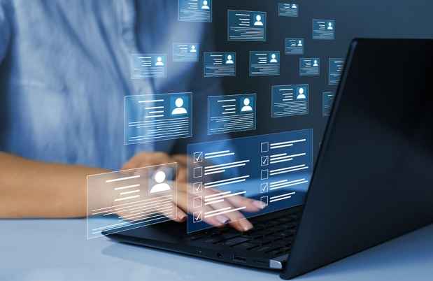 Person using laptop with floating digital profiles