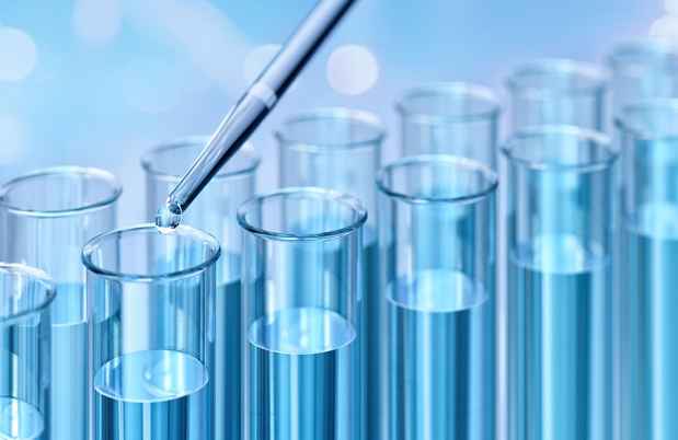 Blue liquid in test tubes with a pipette droplet