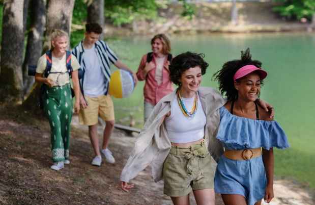 Group of teens walking near a lake