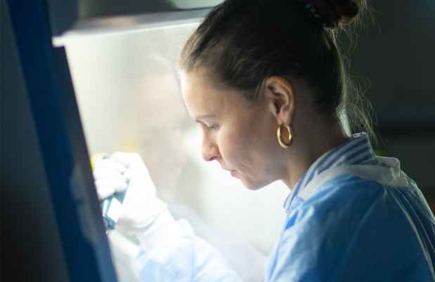Researcher works with lab equipment