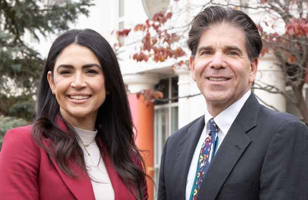 Dr. Fairlee Fabrett and Dr. Daniel Dickstein stand outside
