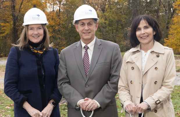 3 VIPs at a groundbreaking holding shovel handles, 2 with hard hats