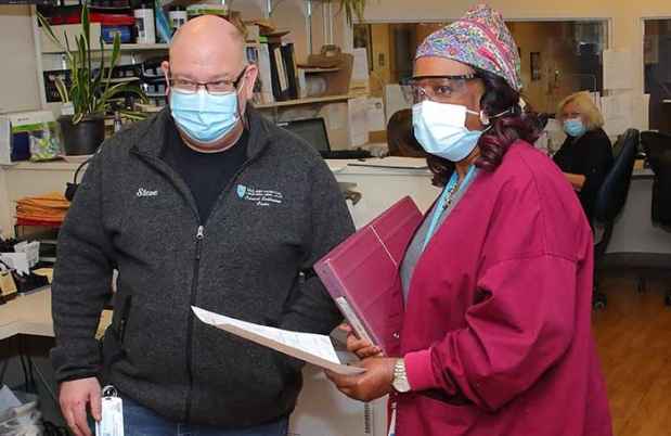 Nurses discuss paperwork
