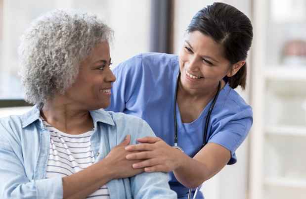 Nurse helps older patient