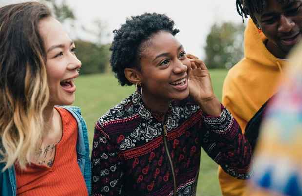 Stock image of diverse teens outside laughing