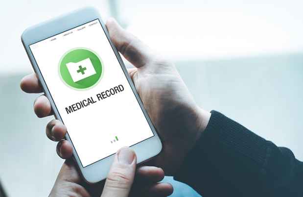 Hand holds smartphone with medical record on screen