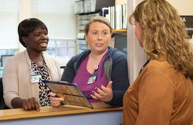Nurses consult at nursing station