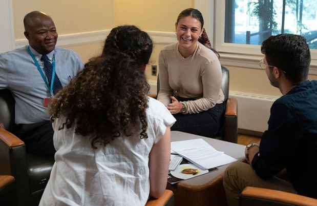 Patients in group therapy sit together and talk