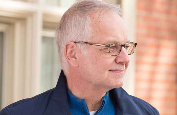 Older man outside smiling