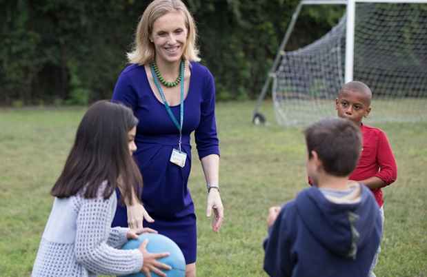 Psychologist plays an outdoors game with kids as part of mental health therapy