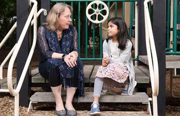 Clinician talks with young girl