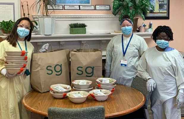 Staff in PPE with in-kind food donations