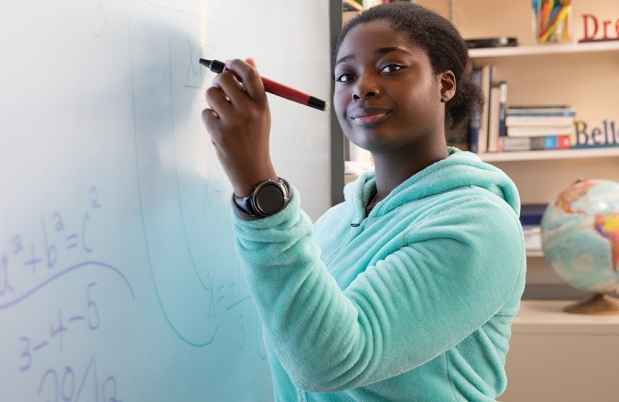 Student at the Arlington School uses a smartboard