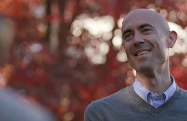 Man outside, color leaves blurry in background