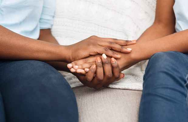 African American couple holding hands.