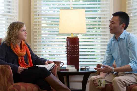 Patient and clinician talk in living room